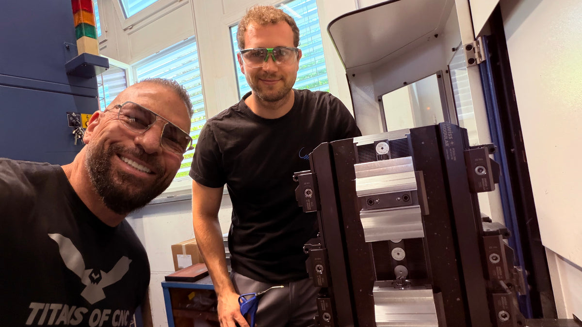 Two visitors beside a Swiss Modular tombstone setup at the facility