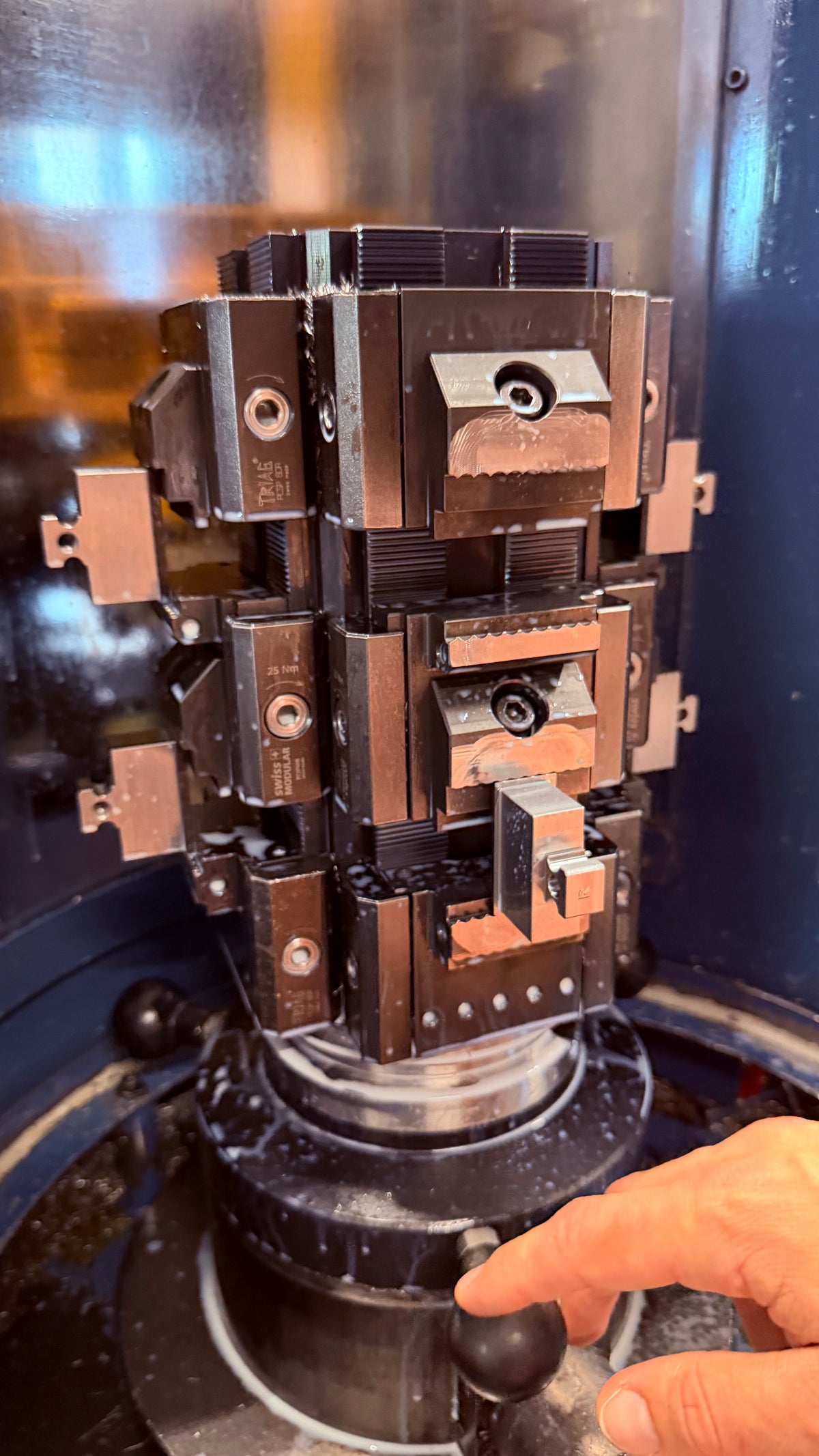 Tombstone fixture and clamped workpieces inside a machine enclosure
